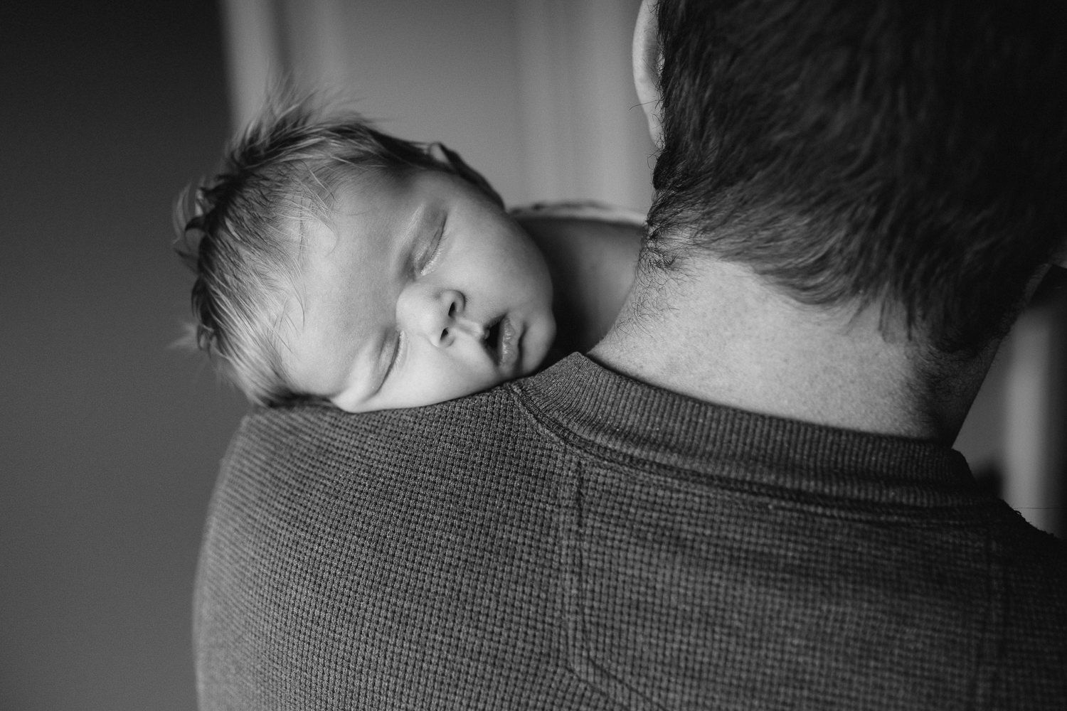2 week old baby girl with lots of red hair sleeping on dad's shoulder - Markham Lifestyle Photos