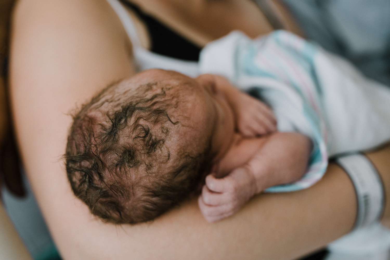 10 hour old baby boy sleeping in mom's arms, close up of hair - Newmarket In-Hospital Photography