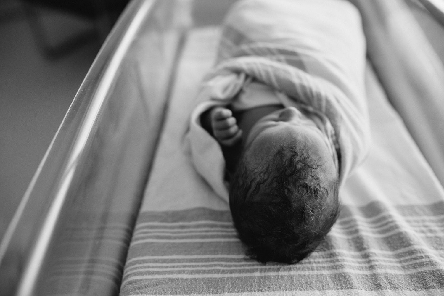 10 hour old baby boy swaddled sleeping in hospital bassinet - Barrie Fresh 48 Photography