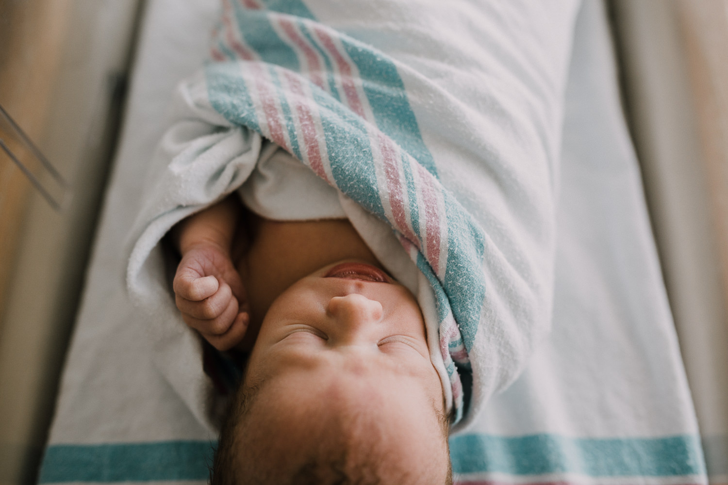10 hour old baby boy in swaddle sleeping in hospital bassinet - Markham Fresh 48 Photography