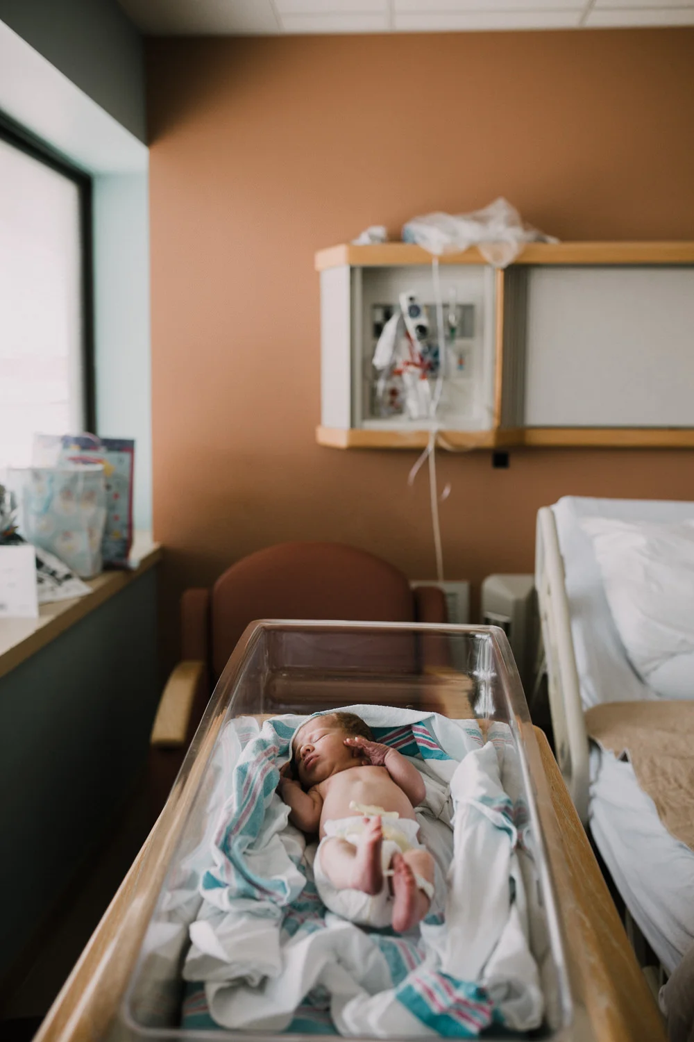 10 hour old baby boy in diaper sleeping in hospital bassinet - Stouffville Fresh 48 Photography
