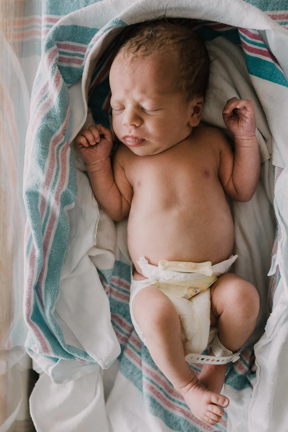 10 hour old baby boy in diaper sleeping in hospital bassinet - Markham Fresh 48 Photography