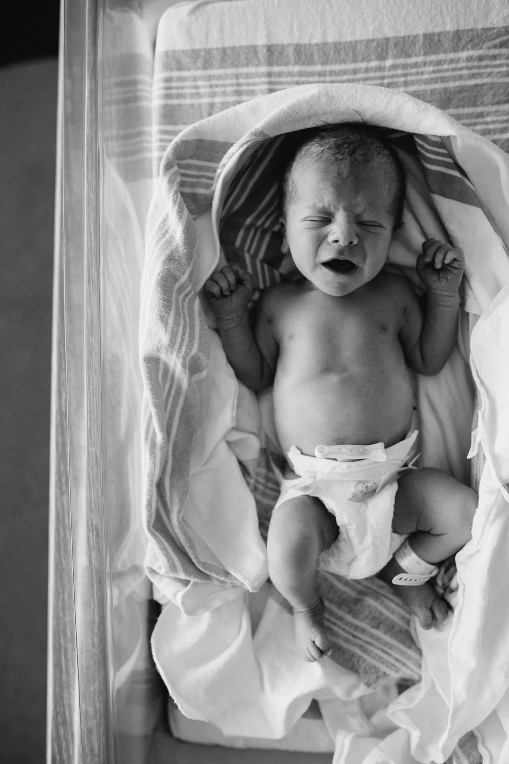 10 hour old baby boy in diaper sleeping in hospital bassinet - Barrie Fresh 48 Photography