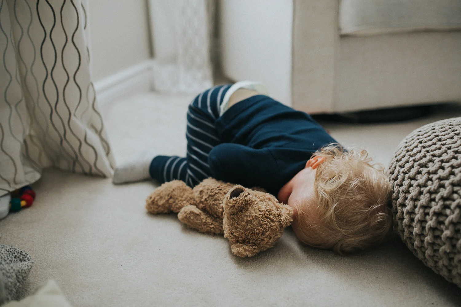 18 month old blonde toddler lying asleep on floor with bum in air - Barrie Documentary Photography