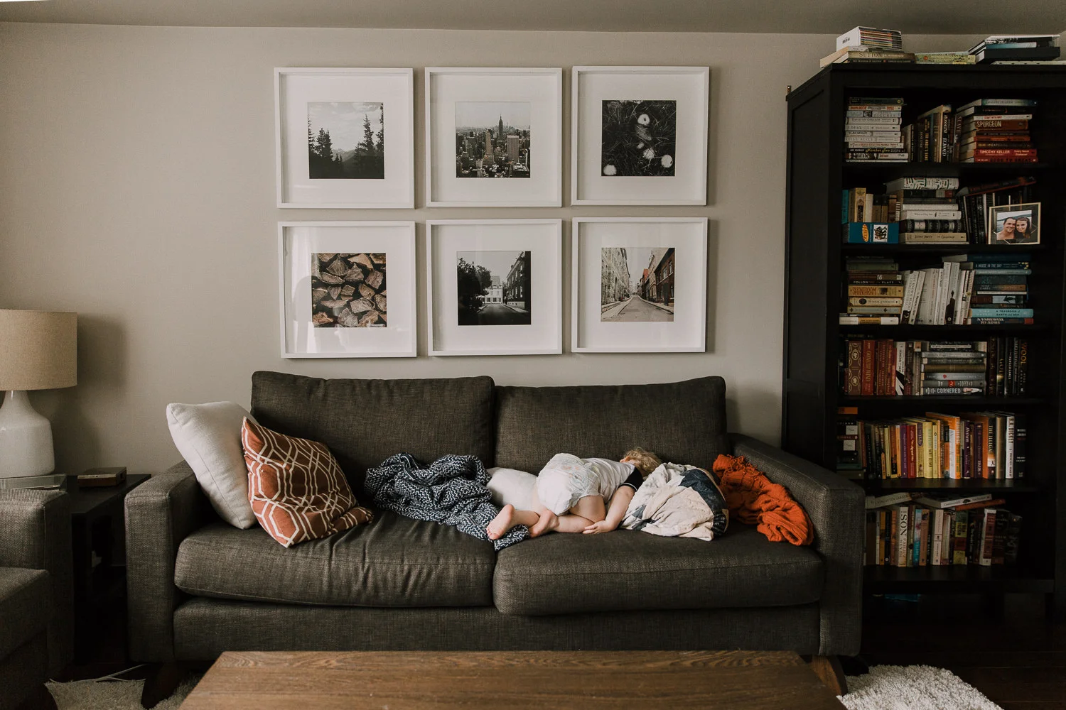 20 month old boy in diaper asleep facedown on couch with bum in the air - Stouffville Family Photography