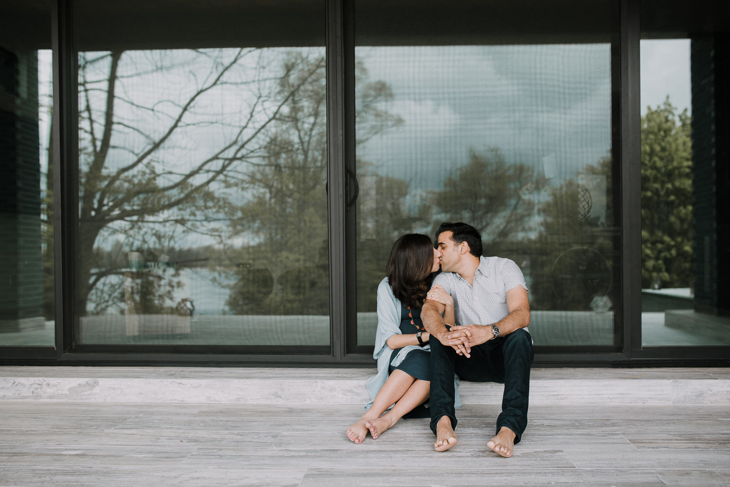 expectant parents sitting on patio, kissing - Barrie Lifestyle Photos