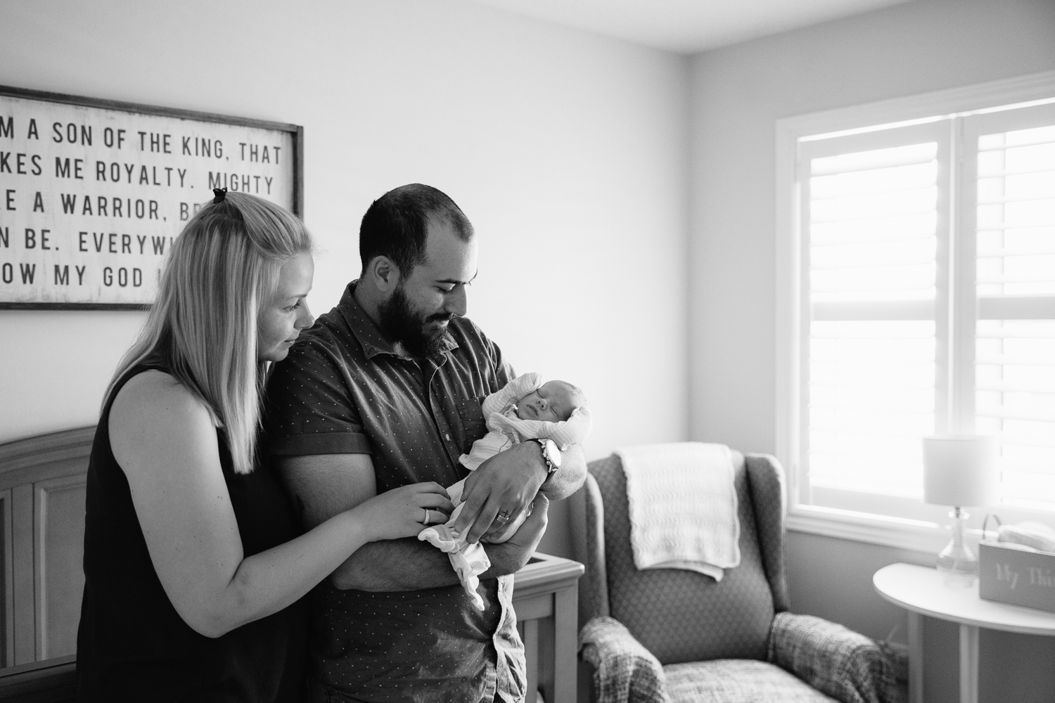 first time parents standing in nursery, dad holding sleeping 2 week old baby son - Barrie In-Home Photography