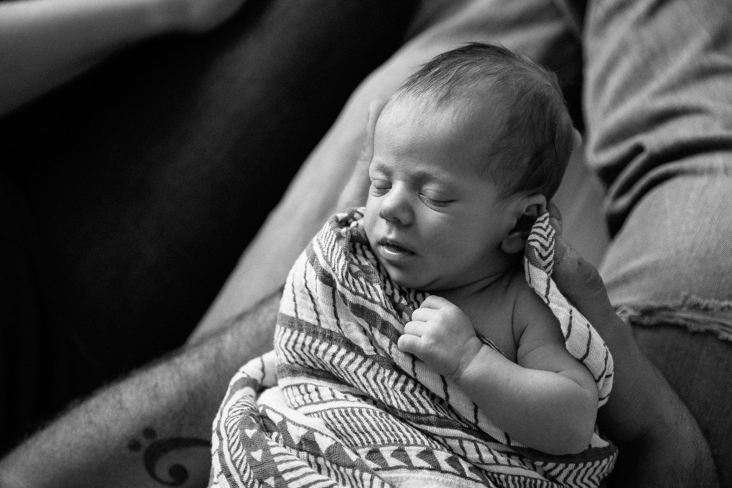 2 week old baby boy in swaddle, asleep in dad's arms - Markham Lifestyle Photos