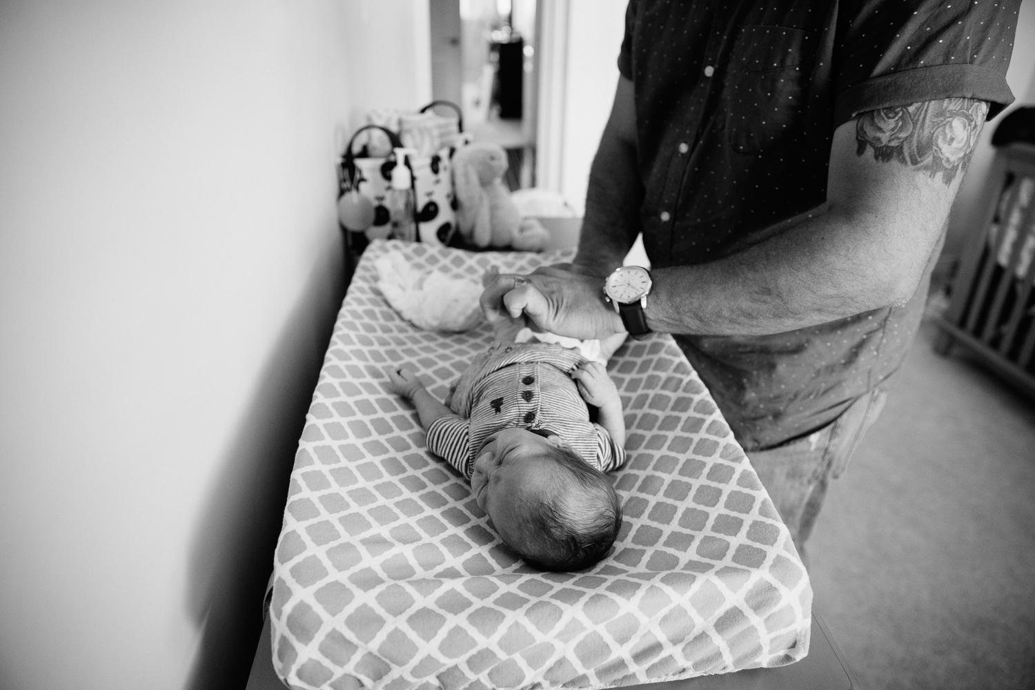 dad changing 2 week old baby boy's diaper in nursery - Markham Lifestyle Photos