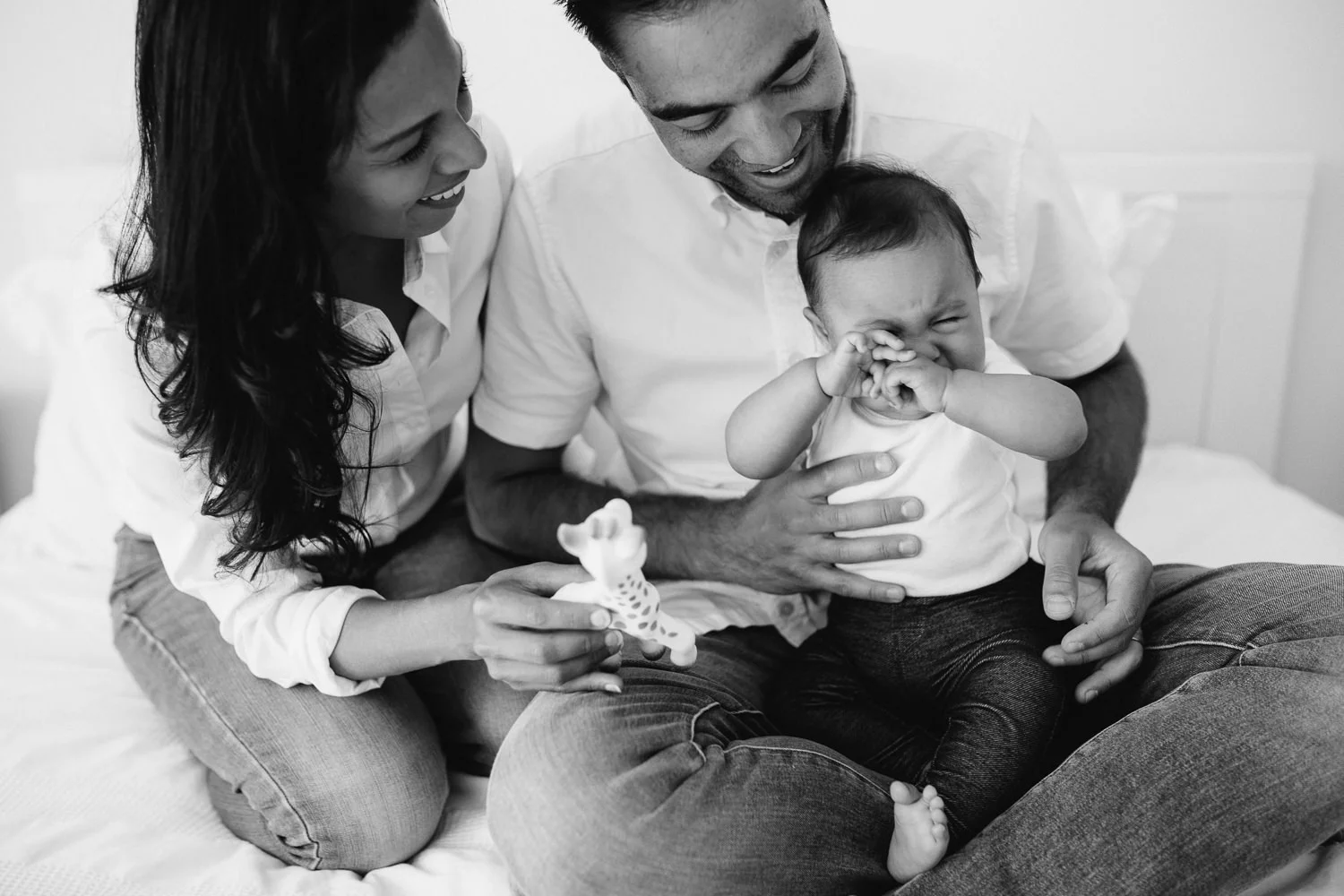 six month old baby girl sits in father's lap, rubbing her eyes and crying - Stouffville Lifestyle Photos