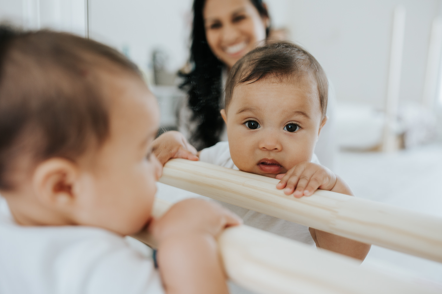 reflection of 6 month old baby girl in mirror, looking at camera - Markham Lifestyle Photography