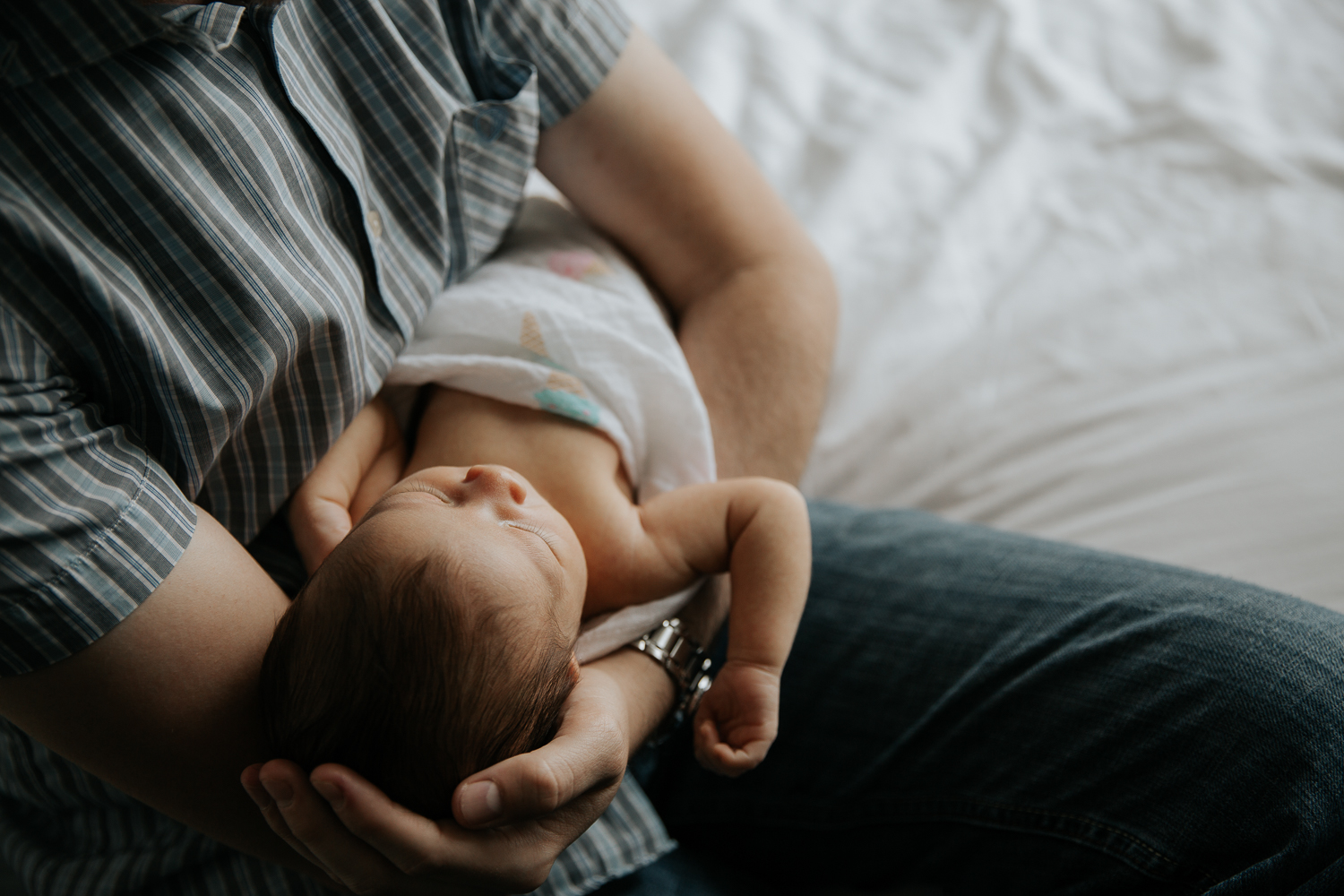 2 week old baby girl in swaddle sleeping in father's arms - Markham In-Home Photos