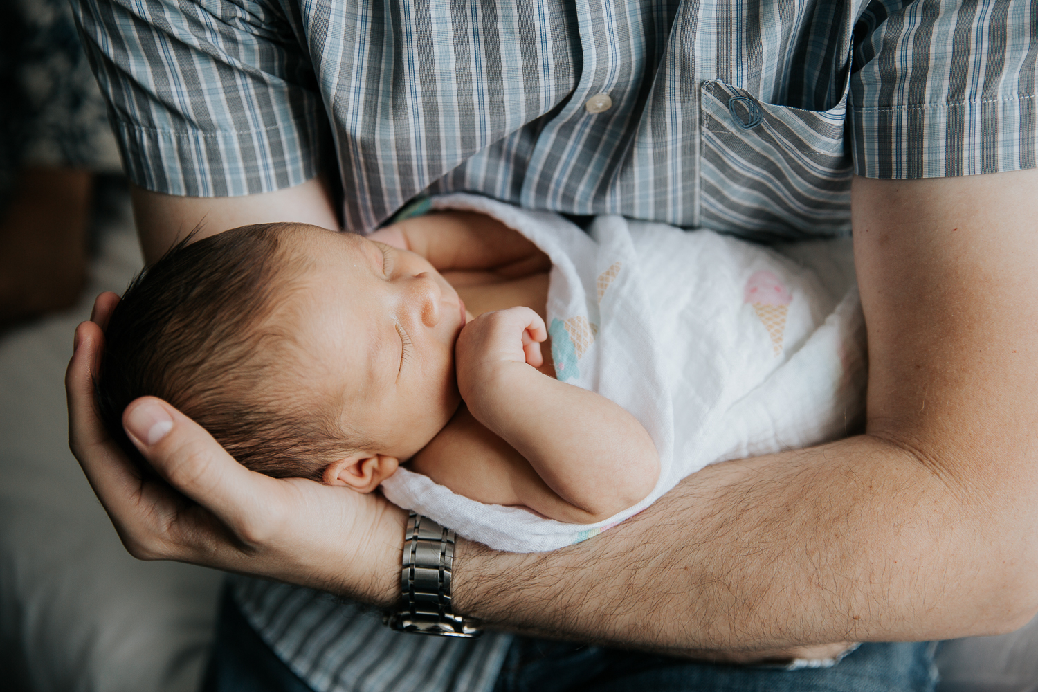 2 week old baby girl in swaddle asleep in father's arms - Newmarket In-Home Photography