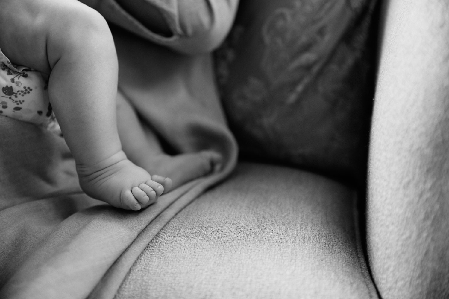2 month old baby girl lying on mom's lap nursing, close up of her feet - GTA Lifestyle Photos