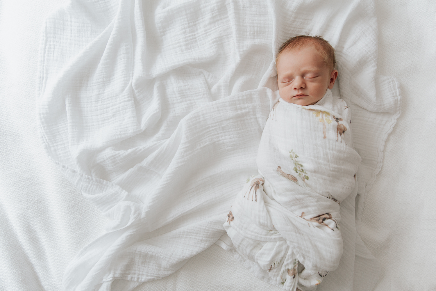3 week old swaddled baby boy with red hair sleeping on bed, full body shot - Markham In-Home Photos