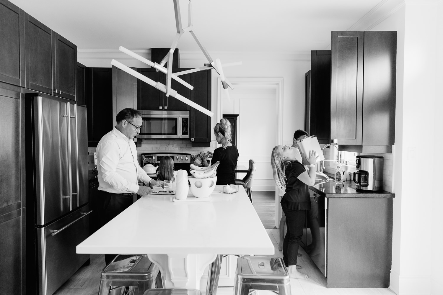 family of 5 in large modern kitchen preparing brunch together - GTA In-Home Photos
