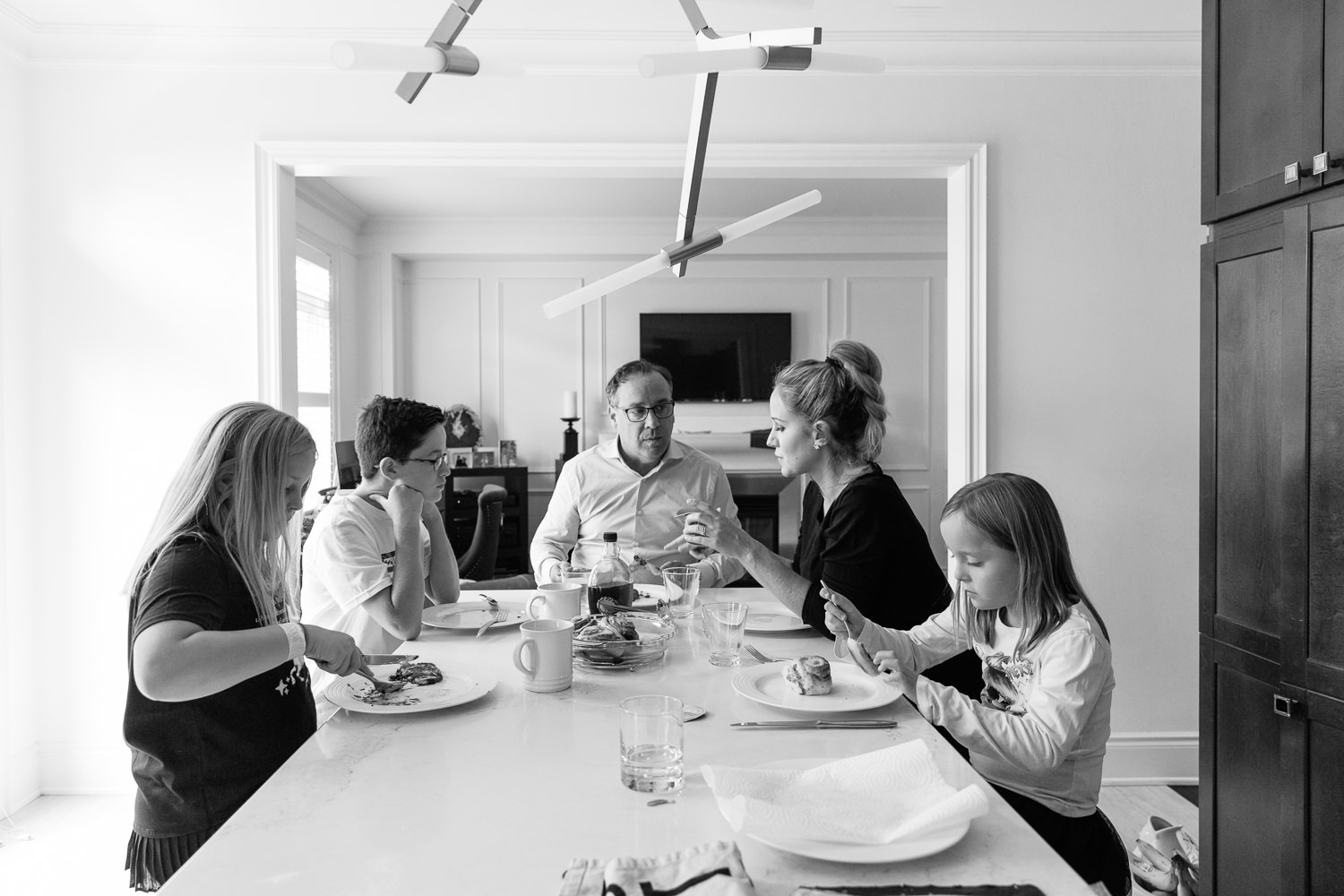 family of 5 sitting at kitchen island eating brunch together - Barrie Lifestyle Photos