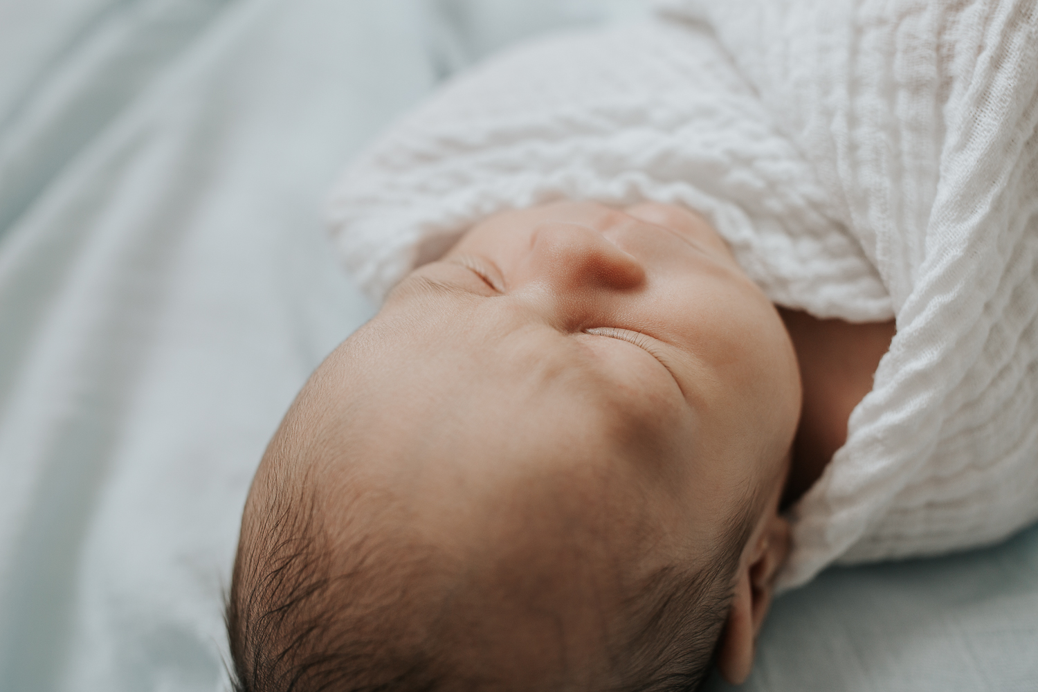 close up of sleeping, swaddled 3 week old baby boy's eyelashes - Newmarket In-Home Photography