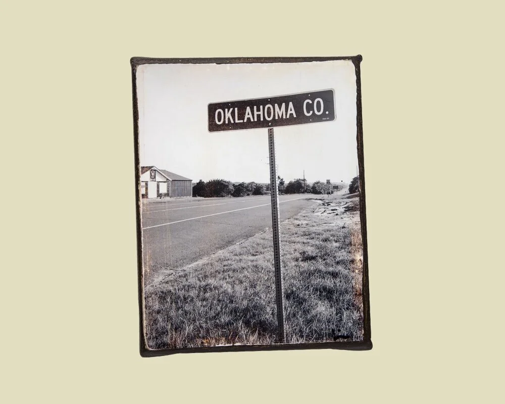 a photo of a road sign that says "oklahoma co" mounted on canvas