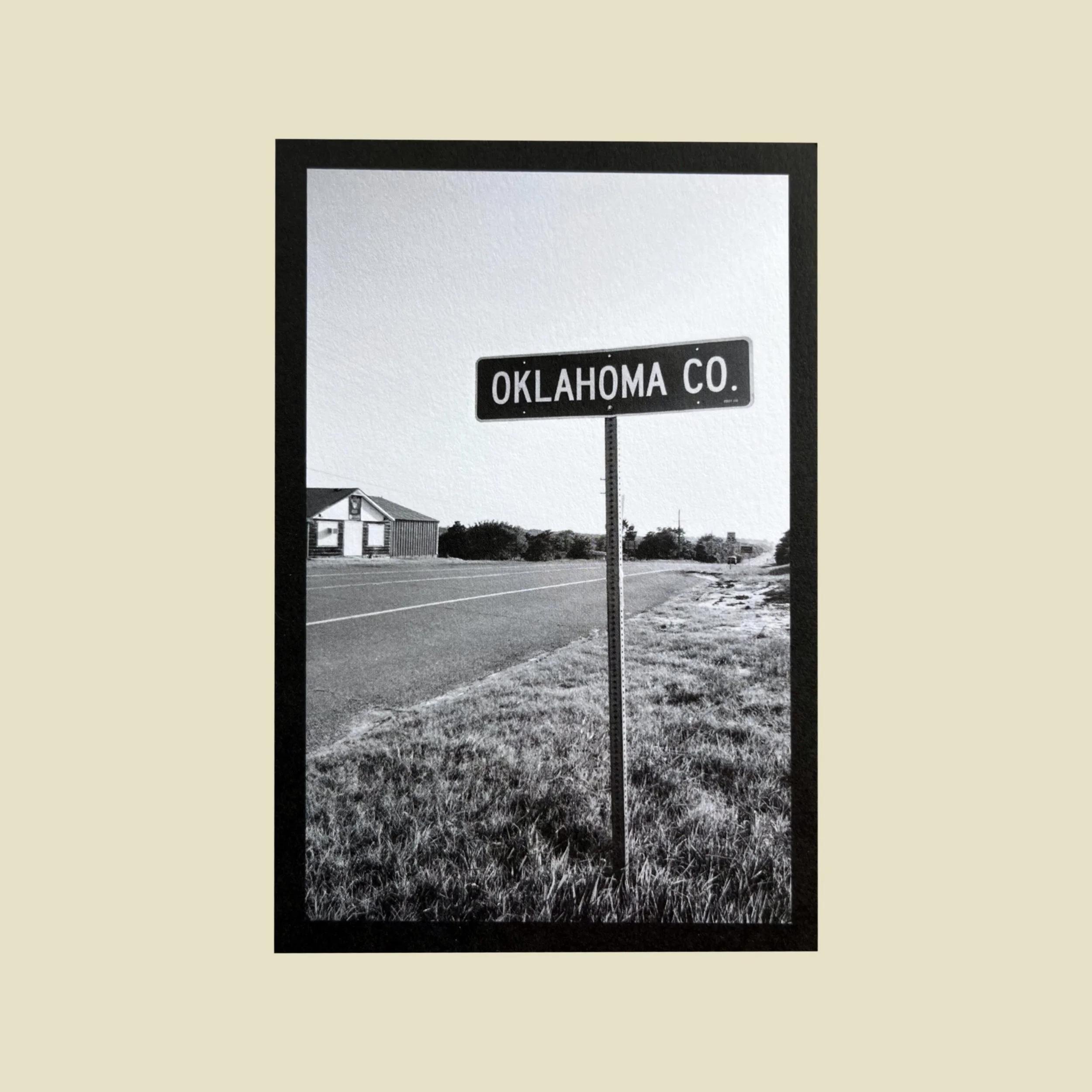 the front of a postcard that is a photo of a road and a sign that reads "oklahoma co."