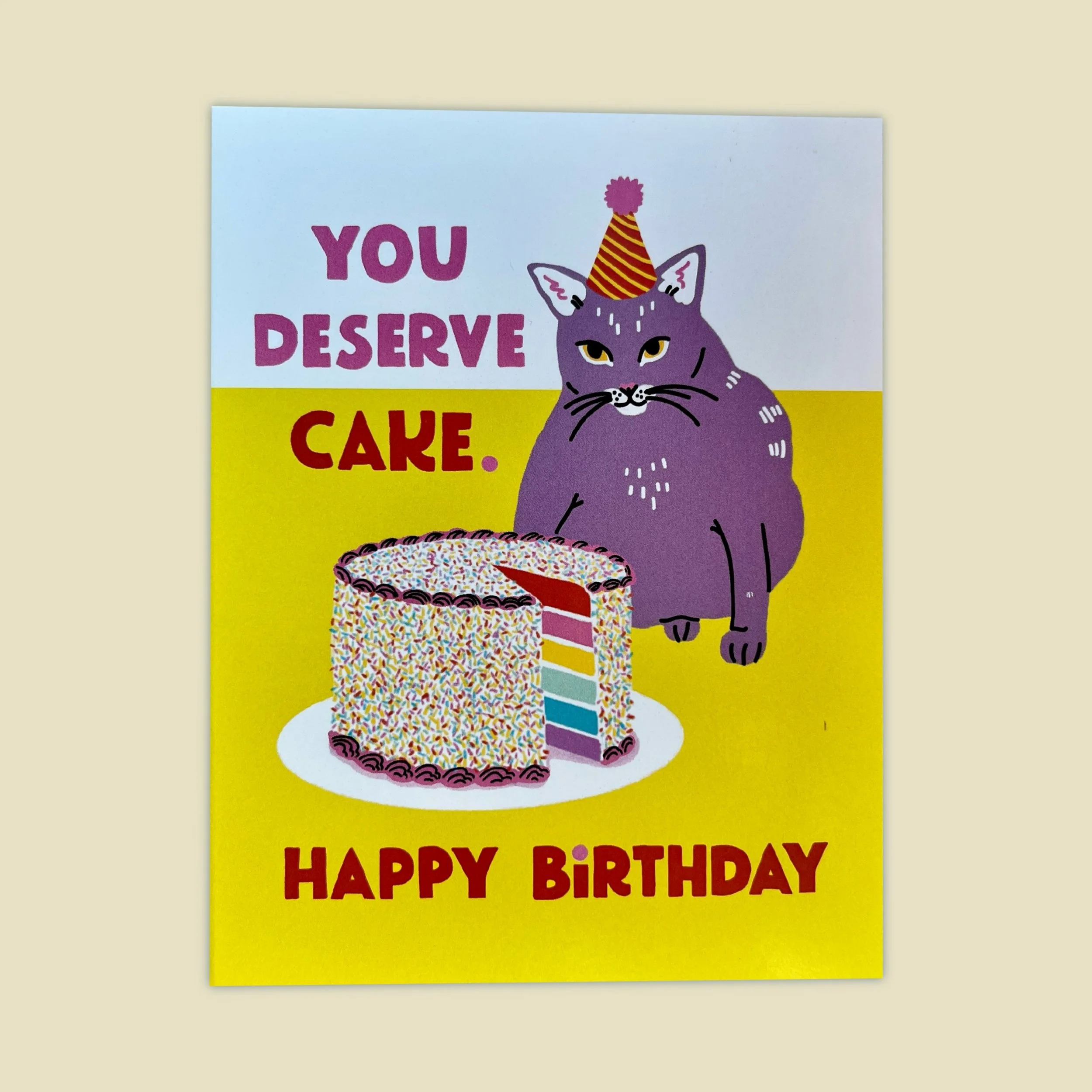 a card of a cat that says "you deserve cake"