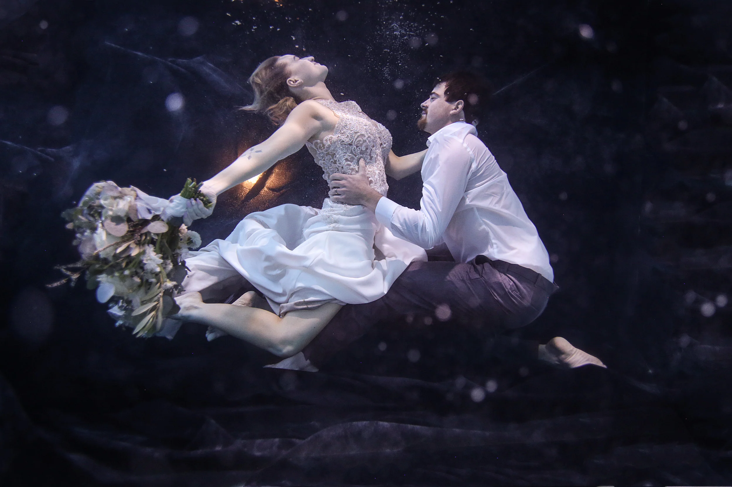 Bride and groom underwater