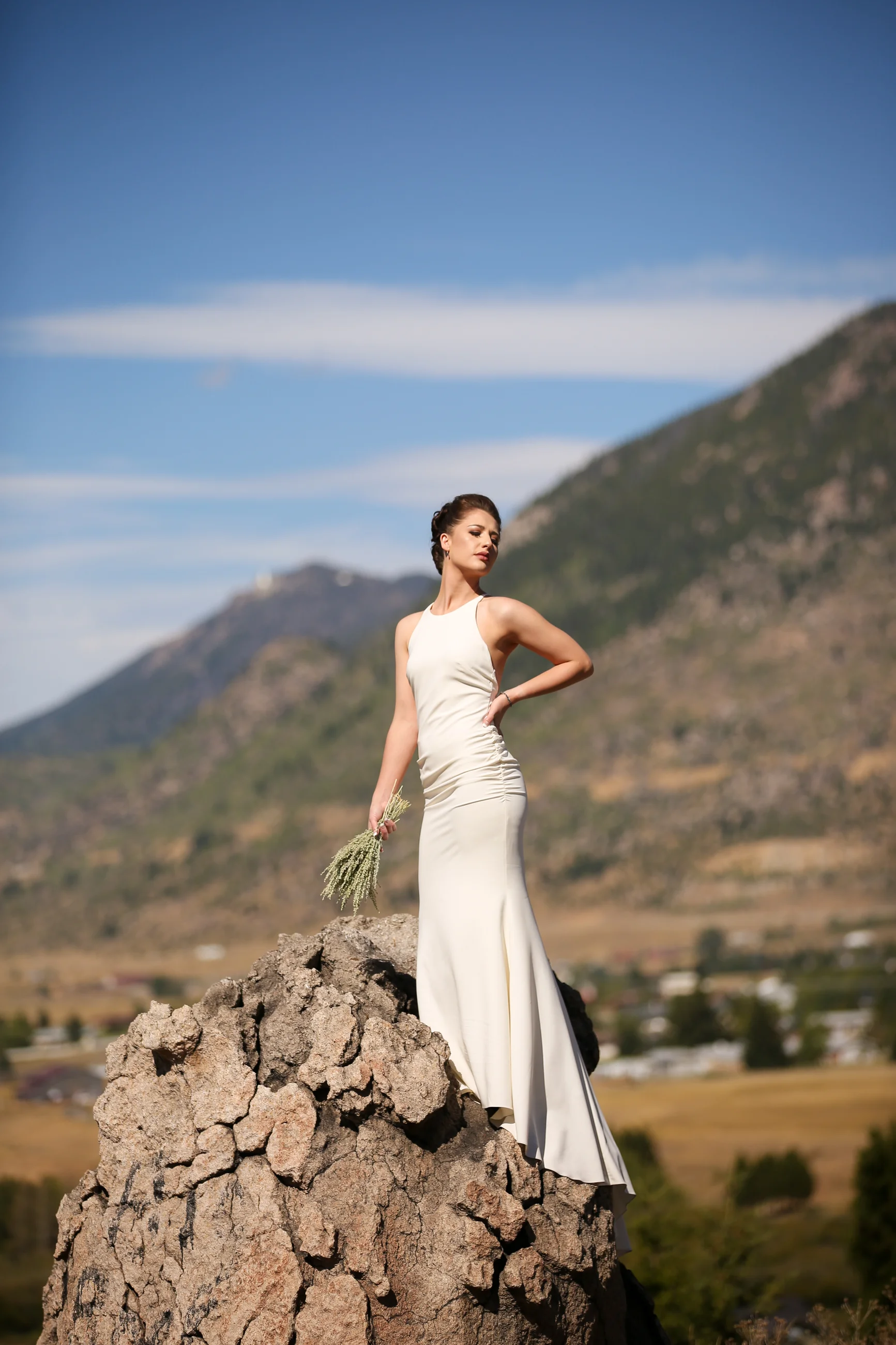 Wedding photography of bride on rock formation