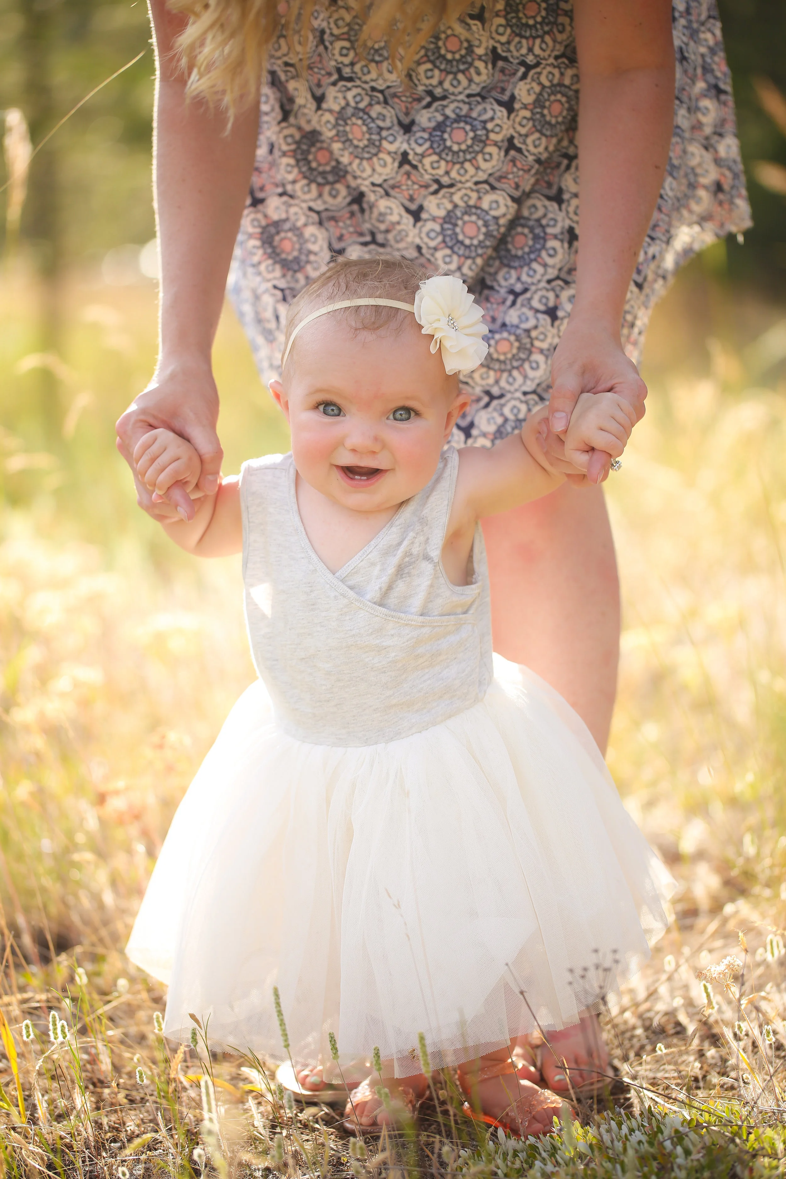 Family portrait of family in Montana baby smiling in grass field at sunset
