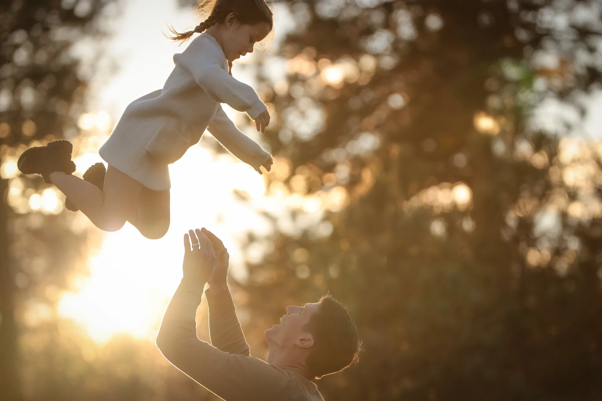 Dad throws daughter in air during family portrait.jpg