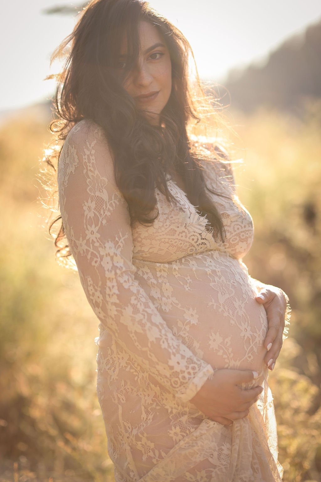 Maternity portrait of belly in white lace gown.jpg