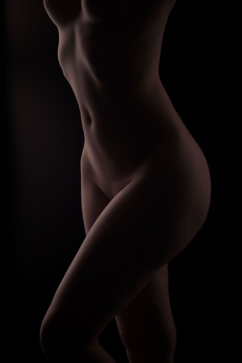 Boudoir portrait of woman with sensual lighting in studio.jpg