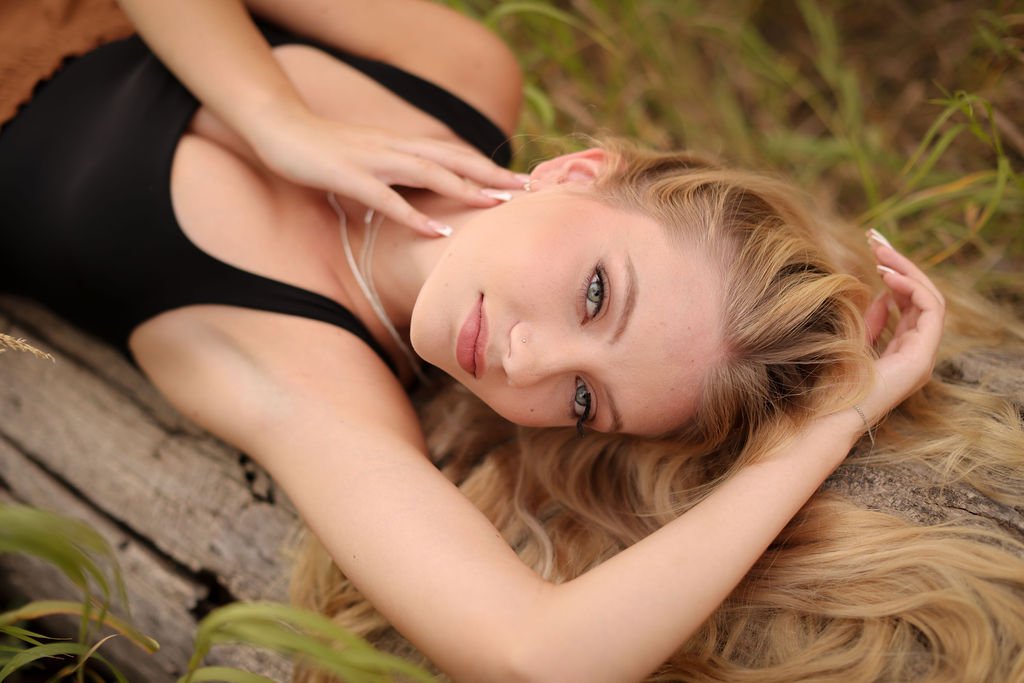 Missoula high school senior girl laying on log.jpg