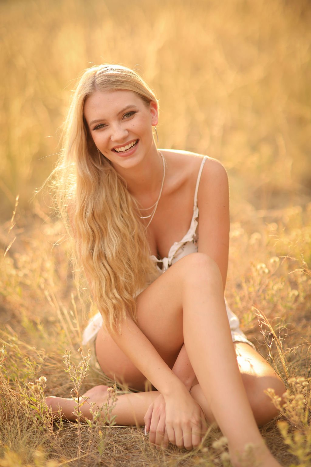 Missoula high school senior portrait smiling in grass field.jpg