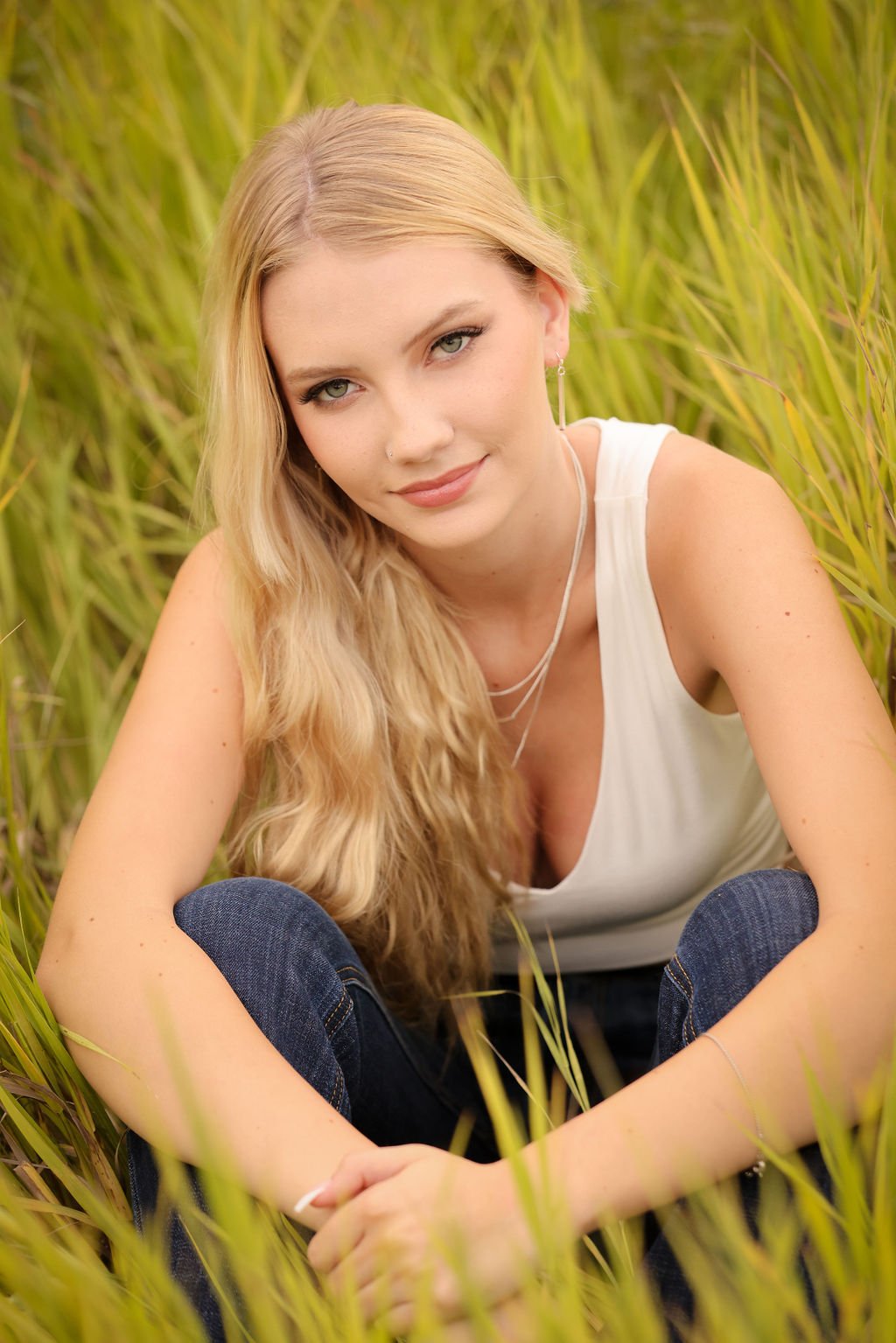 Missoula high school senior sitting in green grass.jpg