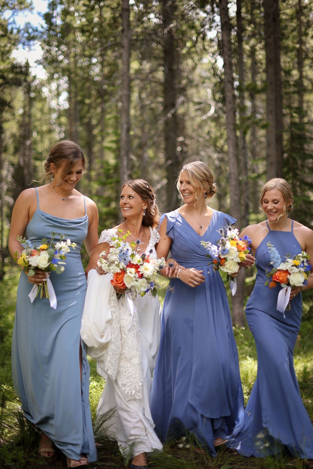 Bridal party walking through Montana woods in Glacier National Park.jpg