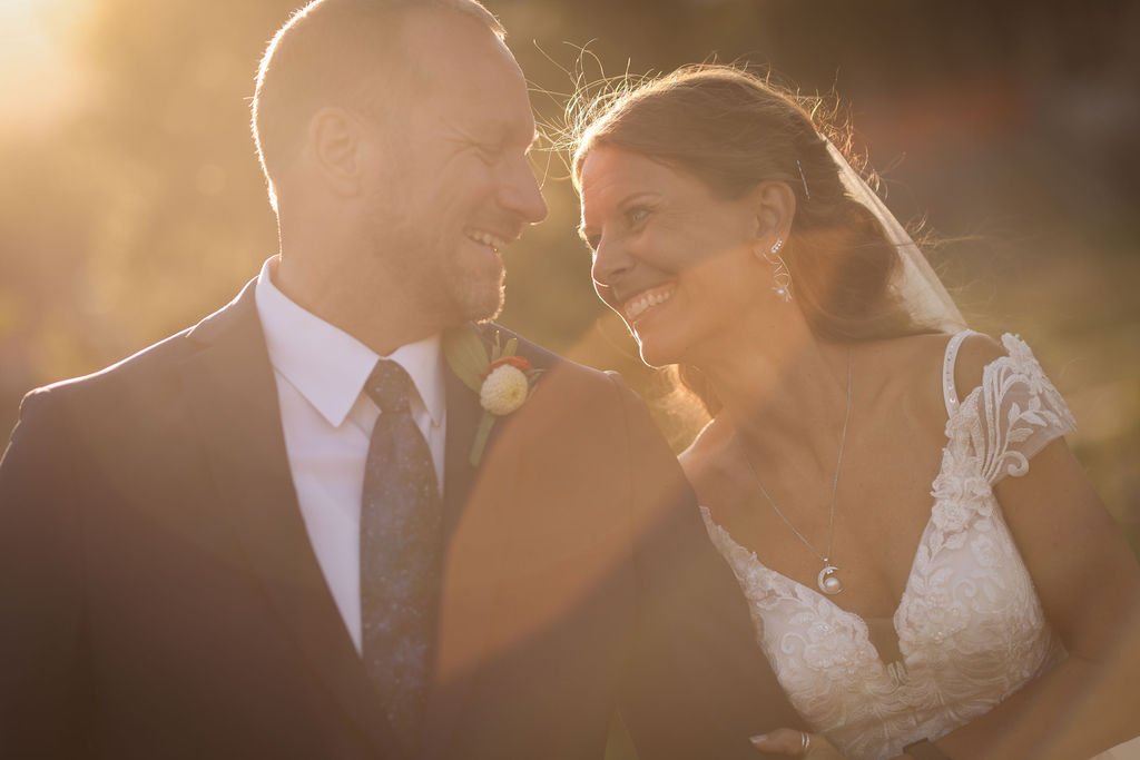 Bride and groom laughing at golden hour.jpg