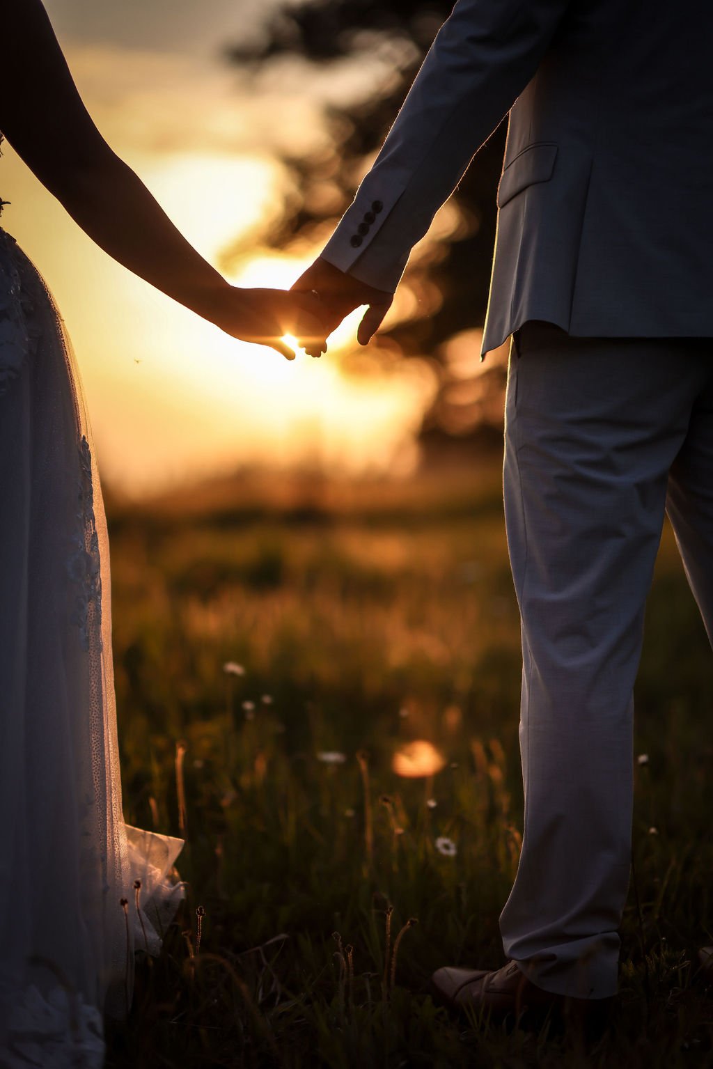 Bride and groom holding hands at sunset at the Silver Knot Wedding Venue.jpg