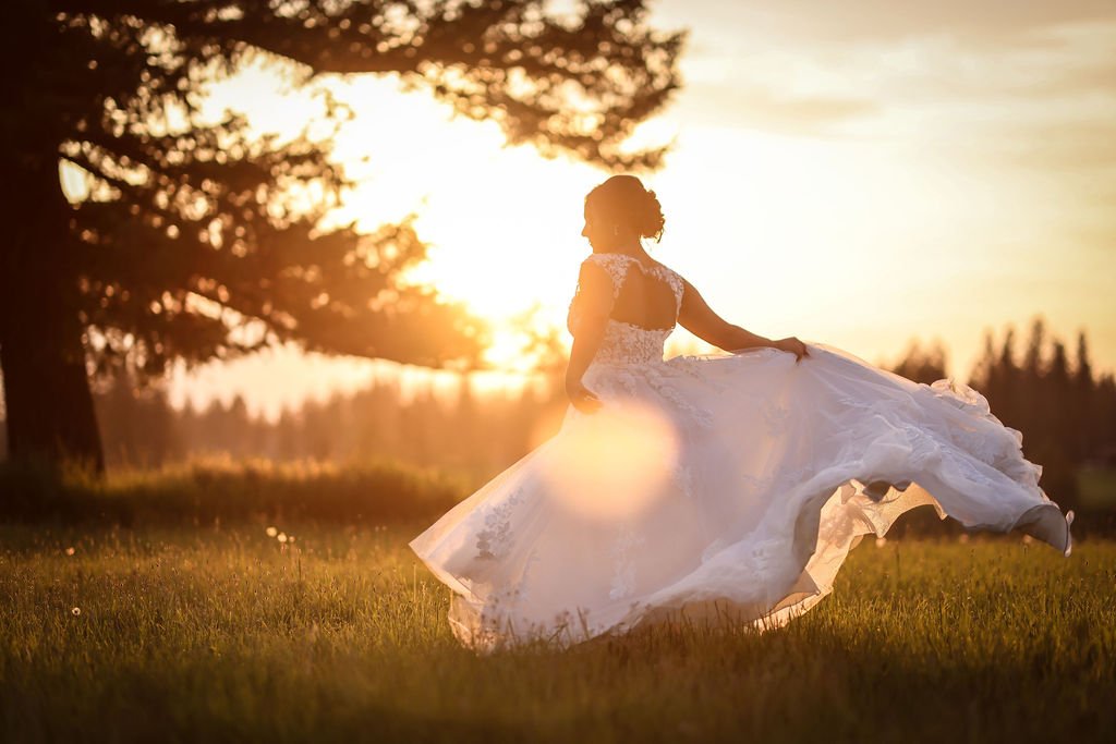 Bride twirling wedding gown at golden hour in Montana.jpg