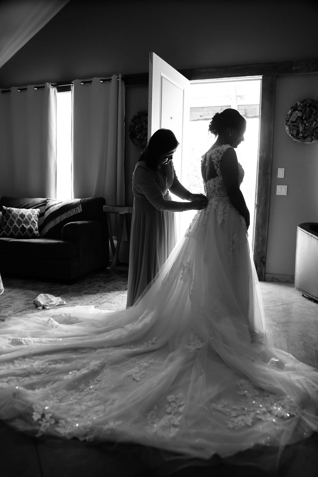 Mother helping bride into wedding gown at Silver Knot in Montana.jpg
