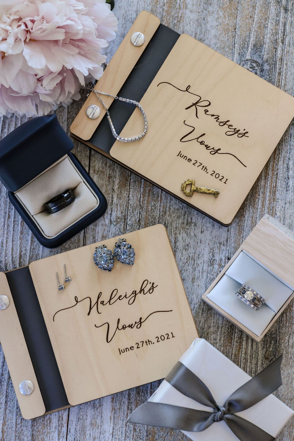 Gorgeous wedding details with rings and vow books.jpg