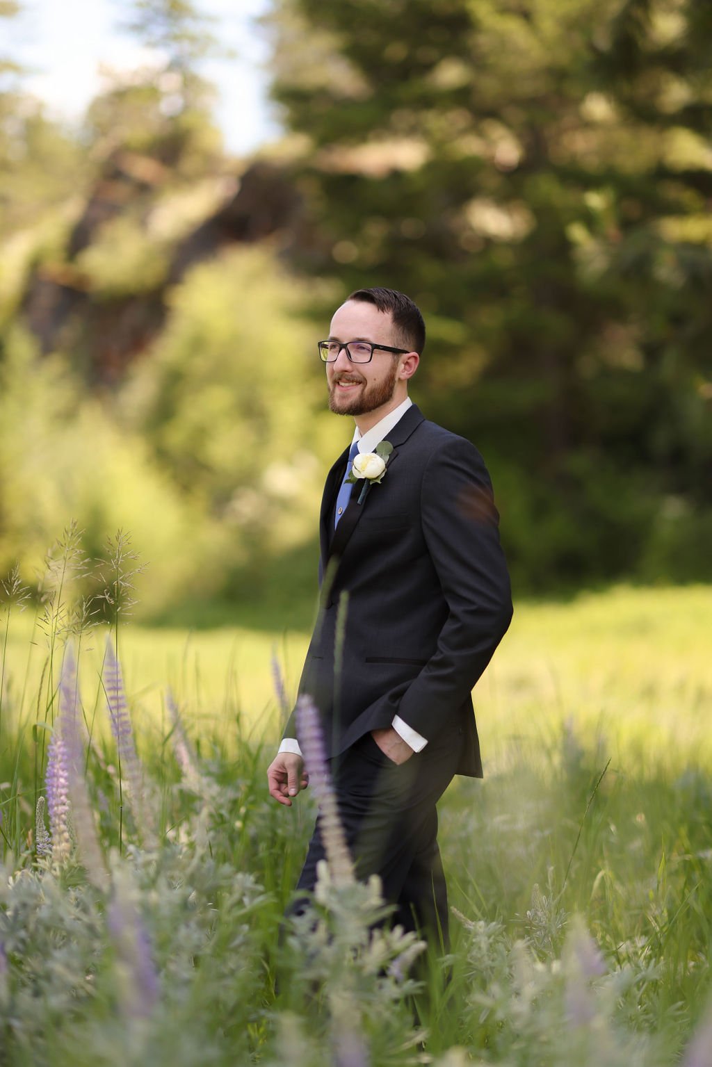 Groom standing in Montana field at The White Raven.jpg