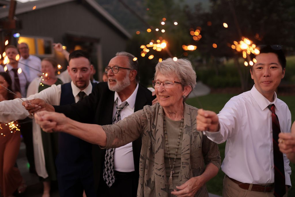 Wedding guests holding sparklers at the White Raven.jpg