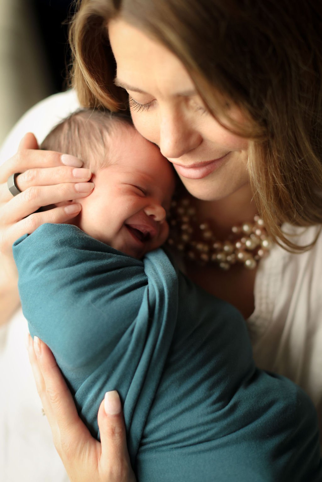 Mom holding her son gently.