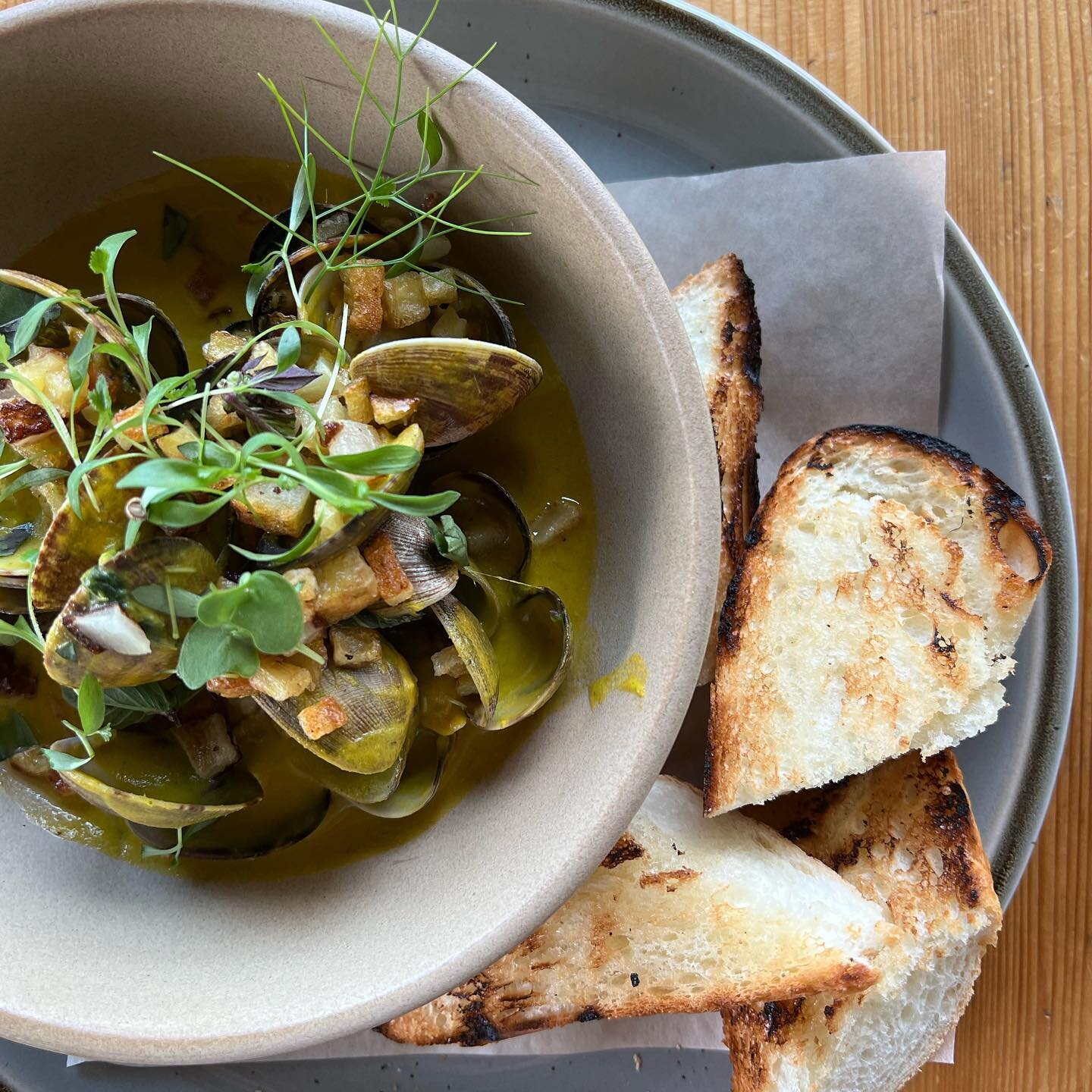 Manila clam and @browngirlfarms speckled hound pumpkin 'chowder' in coconut cream and musarat lime, with fuzzy squash my mom grew (green squash in second pic), Thai basil,  and @fusion.greens cilantro greens, housemade banh mi baguette. #tophatterski