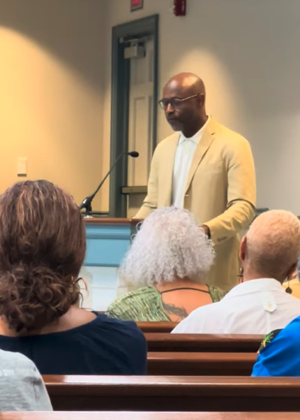 Lewis Long speaking at an event, Art in the Atrium.