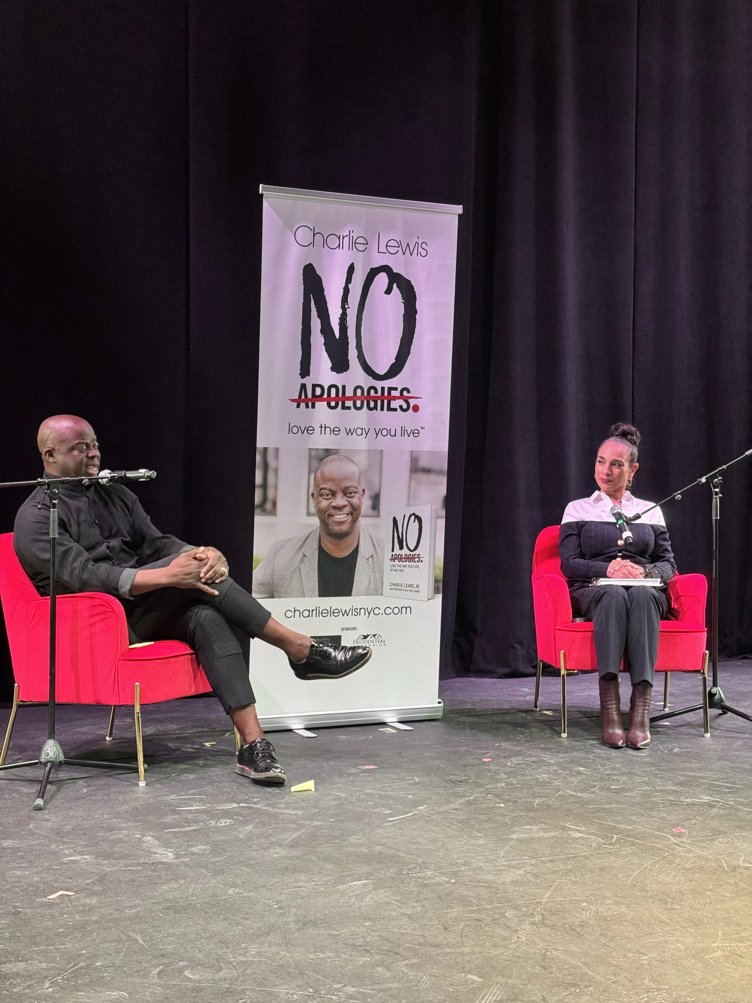 Author Charlie Lewis Jr. speaking with journalist Michelle Miller at the Apollo Theater.