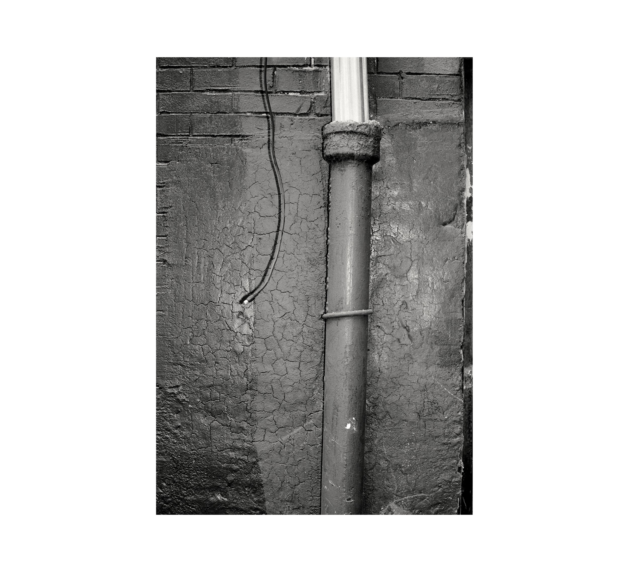   Downspout , 2023 gelatin silver print image 6 1/2 x 4 1/2 in paper 10 x 8 in 