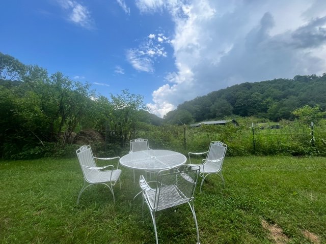 white chairs by garden.jpg