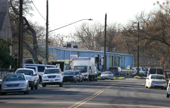 A look along Red Bluff Road, where developers want to put a hotel, replacing the blue warehouse and other businesses along the river's edge.