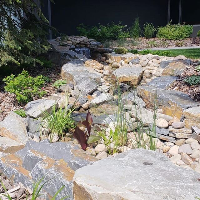 This front yard landscape in Bayview includes a custom-built water feature and paving stone driveway and is a beautiful way to be welcomed home!

Scope Projects 
Landscape Architectural Consulting Construction and Design
Phone: 1-403-949-2785 
scopep